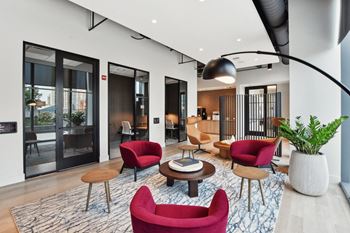 a living room with red chairs and a table  at Cassidy on Canal, Chicago, IL